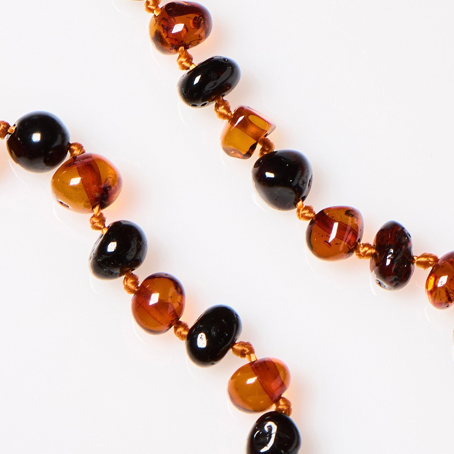 close up of polished cherry and cognac amber stones