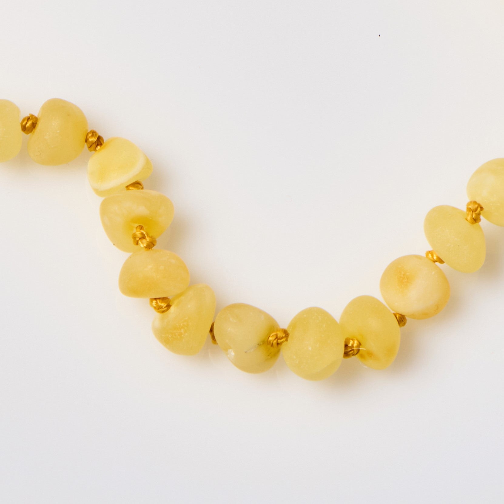 close up of raw baltic amber necklace