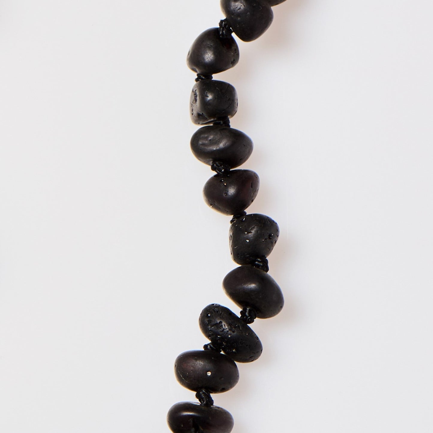 close up of handmade raw cherry amber necklace