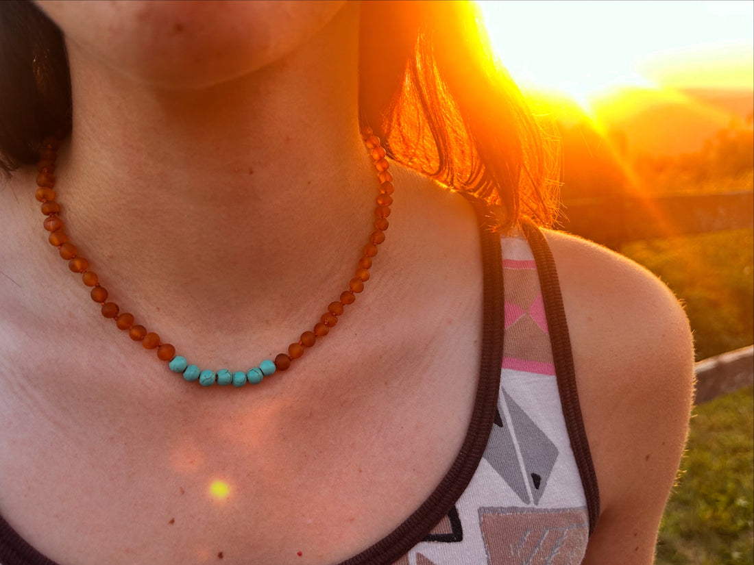 adult female wearing a baltic amber necklace with turquoise