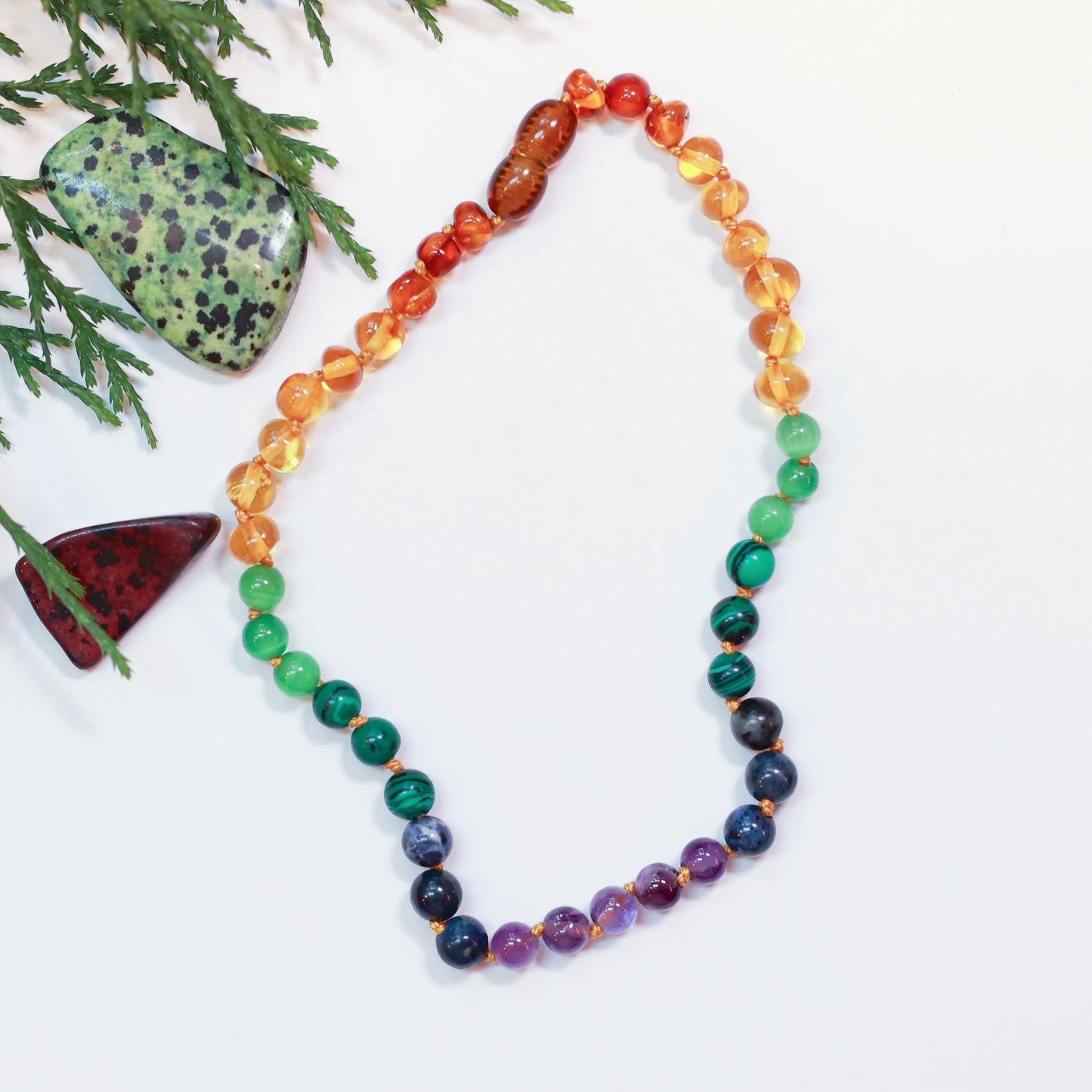 a beaded necklace with baltic amber and semiprecious gemstones for soothing anxiety and pain relief