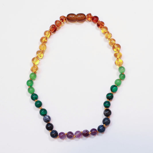 a rainbow beaded amber necklace on a white background