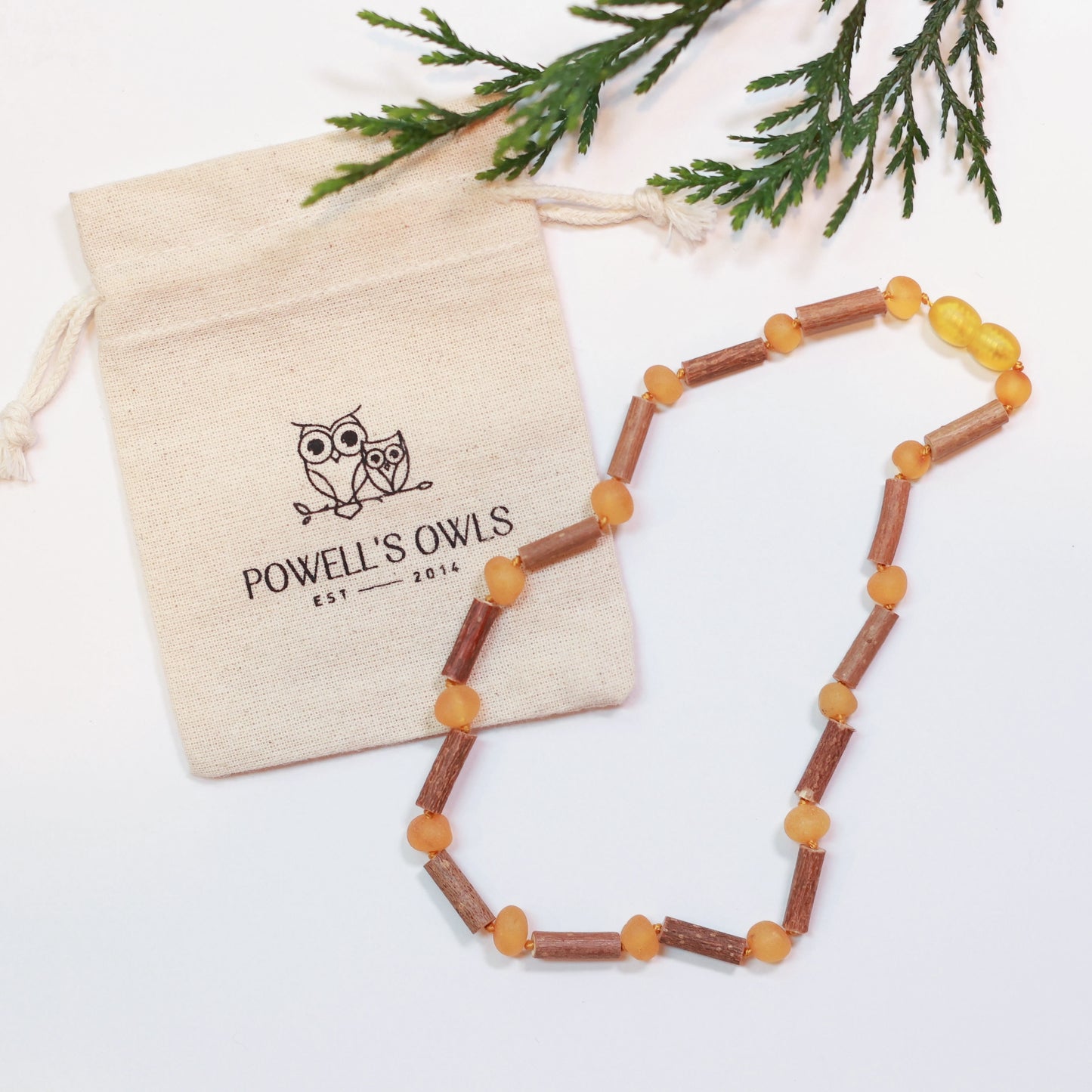Kids' beaded necklace made of Canadian hazelwood and raw honey Baltic amber with a cotton pouch