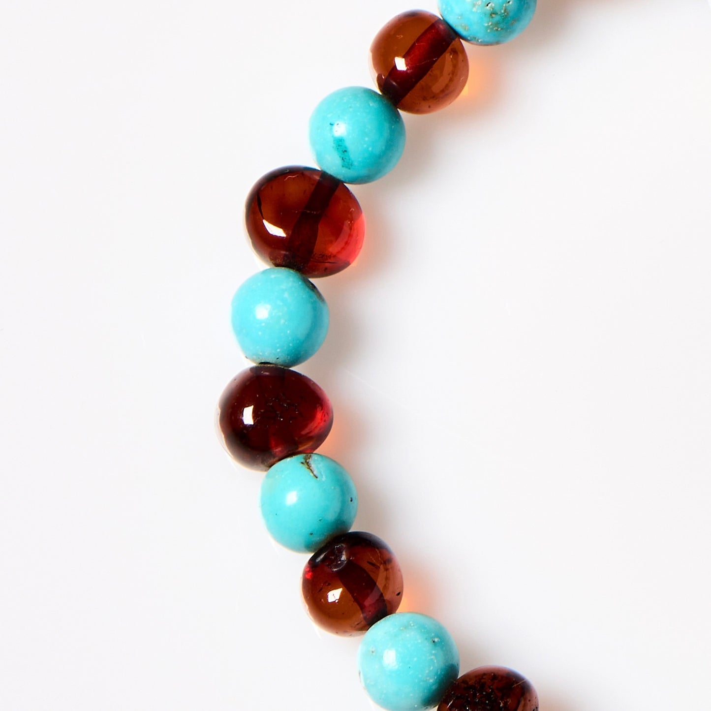 close up of amber bracelet with turquoise stones